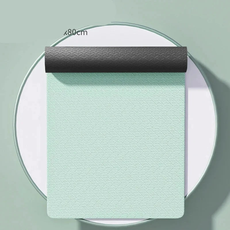 A rolled out beige yoga mat with non-slip properties, displayed with its packaging showing the mat's features such as widened size, non-slip, and odorless qualities.