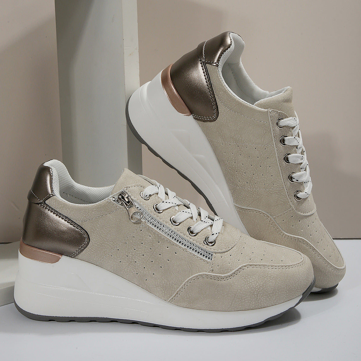 A pair of women's sneakers with lace-up closure, featuring a round toe shape, low-top design, and a flat sole. The sneakers are primarily blue with artificial PU leather and a rubber sole, set against a backdrop of a cobbled street.